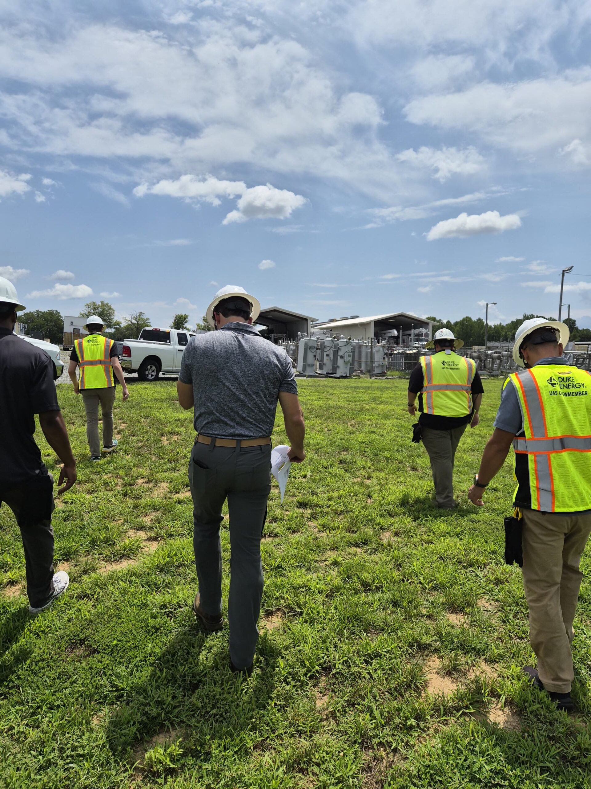 Utility field crew in high visibility vests working on site during an infrastructure survey